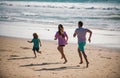 Father, mother and child running jogging on the beach. Concept healthy family lifestyle. Summer people vacation at sea. Royalty Free Stock Photo