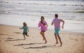Father, mother and child running jogging on the beach. Concept healthy family lifestyle. Summer people vacation at sea. Royalty Free Stock Photo