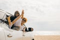 Father, mother and child smiling having fun sitting in compact white car windows raise hand wave bye bye Royalty Free Stock Photo