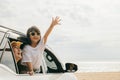 Father, mother and child smiling having fun sitting in compact white car windows raise hand wave bye bye Royalty Free Stock Photo