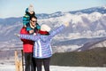 Father, mother and children are having fun and playing on snowy winter walk in nature. Royalty Free Stock Photo