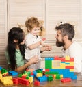 Father, mother and cute kid on light wooden background. Royalty Free Stock Photo