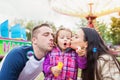 Father, mother and daughter blowing bubbles, family in amusement Royalty Free Stock Photo