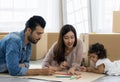 Father Mother and daughter drawing and coloring with colored pencils lying down on the floor. Happy family moment in the house.Art Royalty Free Stock Photo