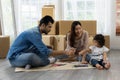 Father Mother and daughter drawing and painting coloring with watercolor lying down on the floor. Happy family moment in the house Royalty Free Stock Photo