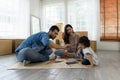 Father Mother and daughter drawing and painting coloring with watercolor lying down on the floor. Happy family moment in the house Royalty Free Stock Photo