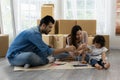 Father Mother and daughter drawing and painting coloring with watercolor lying down on the floor. Happy family moment in the house Royalty Free Stock Photo