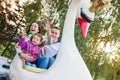 Father, mother, daughter enjoying fun fair ride, amusement park Royalty Free Stock Photo