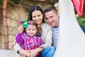 Father, mother, daughter enjoying fun fair ride, amusement park Royalty Free Stock Photo