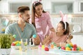 Father, mother and daughter painting Easter eggs Royalty Free Stock Photo