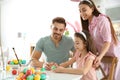 Father, mother and daughter painting Easter eggs in kitchen Royalty Free Stock Photo