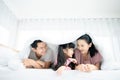 Father and mother with daughter relaxing on bed and enjoy funny Royalty Free Stock Photo