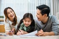 Father, mother and daughter smile drawing art picture together on paper Royalty Free Stock Photo