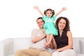 Father, mother and daughter on white leather sofa