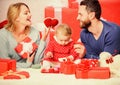 Father, mother and doughter child. Valentines day. Red boxes. Love and trust in family. Bearded man and woman with Royalty Free Stock Photo