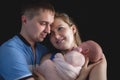 Father and mother hold a baby, Family care newborn concept