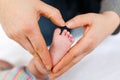 Father or mother holding foot of newborn baby Royalty Free Stock Photo