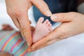 Father or mother holding foot of newborn baby Royalty Free Stock Photo