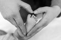 Father or mother holding foot of newborn baby Royalty Free Stock Photo