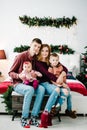 The father, mother holds little son and daughter near Christmas tree. Happy New Year and Merry Christmas. Christmas decorated Royalty Free Stock Photo