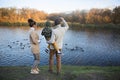 Father, mother and little son feeding ducks Royalty Free Stock Photo