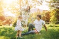 Father and mother play with his daughter with soapbubble