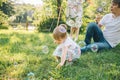 Father and mother play with his daughter with soapbubble