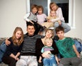 Father, mother and seven children at home.