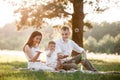 Father, mother and son blow soap bubbles in the park together on a sunny summer day. happy family having fun outdoor Royalty Free Stock Photo