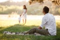 Father, mother and son blow soap bubbles in the park together on a sunny summer day. happy family having fun outdoor Royalty Free Stock Photo