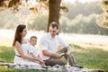 Father, mother and son blow soap bubbles in the park together on a sunny summer day. happy family having fun outdoor Royalty Free Stock Photo