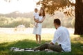 Father, mother and son blow soap bubbles in the park together on a sunny summer day. happy family having fun outdoor Royalty Free Stock Photo