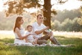 Father, mother and son blow soap bubbles in the park together on a sunny summer day. happy family having fun outdoor Royalty Free Stock Photo