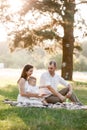 Father, mother and son blow soap bubbles in the park together on a sunny summer day. happy family having fun outdoor Royalty Free Stock Photo