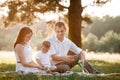 Father, mother and son blow soap bubbles in the park together on a sunny summer day. happy family having fun outdoor Royalty Free Stock Photo