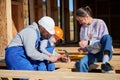 Father, mother and son building wooden frame house. Royalty Free Stock Photo