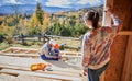 Father, mother and son building wooden frame house. Royalty Free Stock Photo