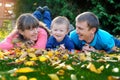 Father, mother and son happy family on a green lawn in the fall Royalty Free Stock Photo