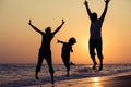 Father mother and son playing on the beach at the sunset time. Royalty Free Stock Photo