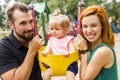 Father, mother with their daughter have fun on a swing Royalty Free Stock Photo