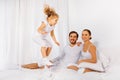 Father, mother and their daughter jumping on bed Royalty Free Stock Photo