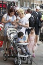 Father, mother and three children looking in the phone route around Piccadilly Circus