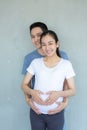 The father and mother wearing a wedding ring are making heart-shaped hands on the belly of the pregnancy Royalty Free Stock Photo