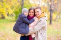 Father and Mother With Young Son On hands Autumn Park Royalty Free Stock Photo