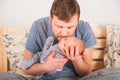 Father and newborn in Scandi bedroom interior. The father sings a lullaby to the child. Parent calms the baby before going to bed