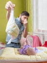 Father od dad is changing diaper that smell. Baby care concept Royalty Free Stock Photo