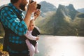 Father photographer hiking with baby carrier in mountains travel family lifestyle vacations with infant child