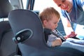 Father placing his son in the car seat Royalty Free Stock Photo