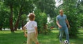 Father play football with son on green lawn closeup. Dad enjoy game with boy. Royalty Free Stock Photo