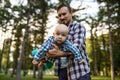 Father play with his little baby in summer park